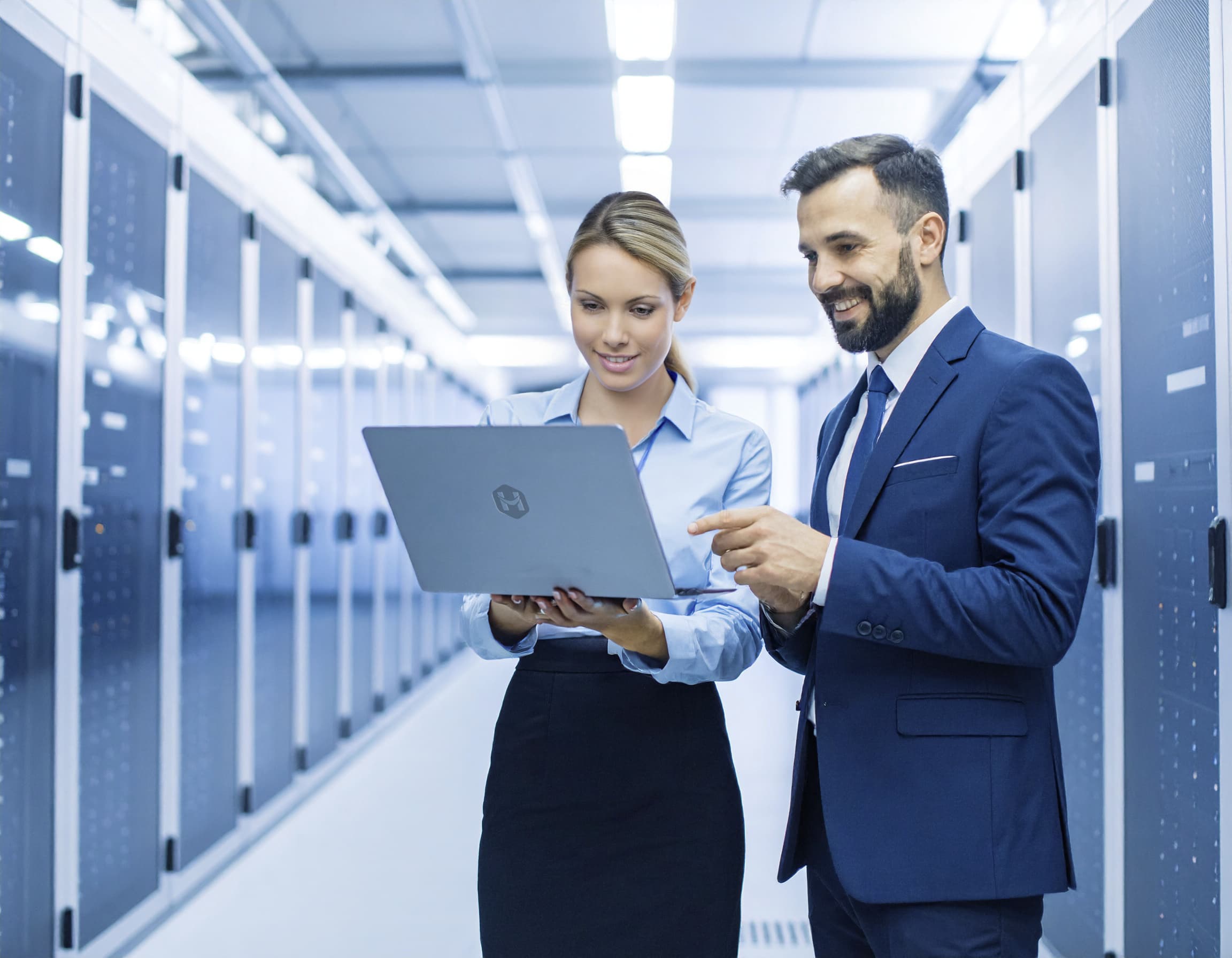 Two people inside a server room